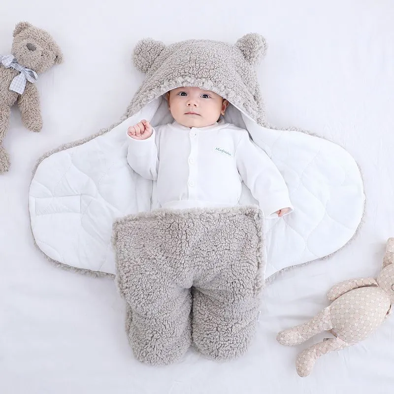 Baby quilted sleeping bag wrapper in cotton blend fabric, shown in a light blue colour.