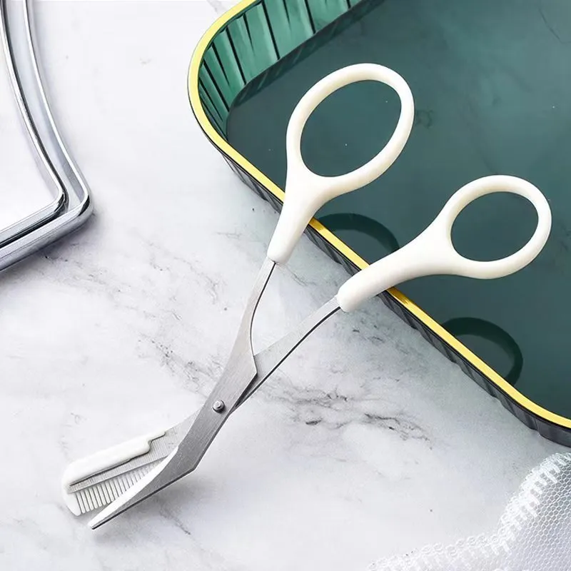 Curved moon-shaped eyebrow trimmer with a cutting comb on a white background.