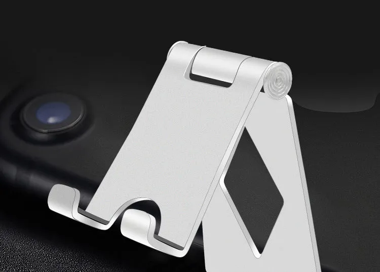 Aluminium alloy mobile desktop stand folding bracket in silver on a desk with a smartphone
