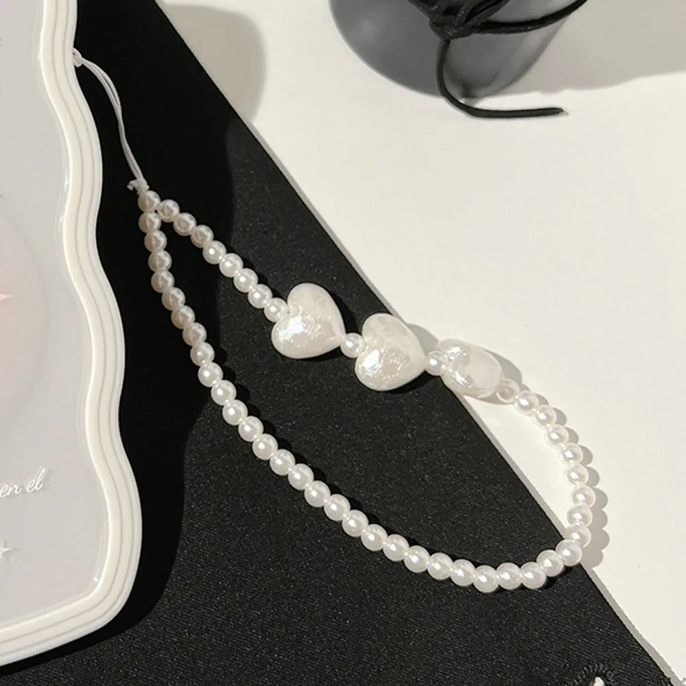 Clear iPhone case with a raised ice bow design, shown next to a white phone lanyard.
