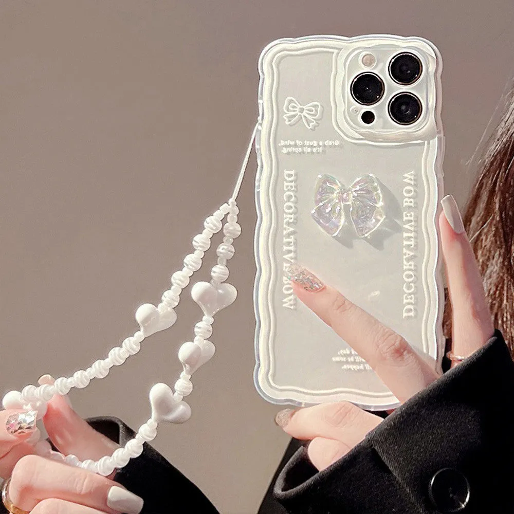 Clear iPhone case with a raised ice bow design, shown next to a white phone lanyard.