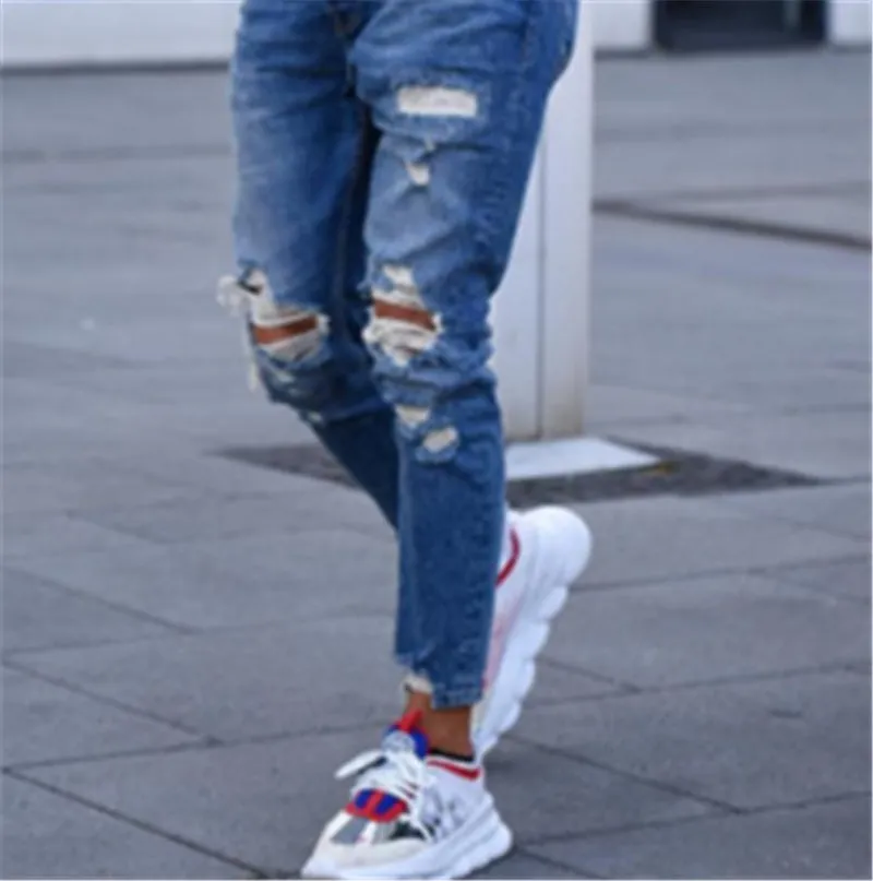 Men's distressed blue jeans with hole detailing in cotton fabric