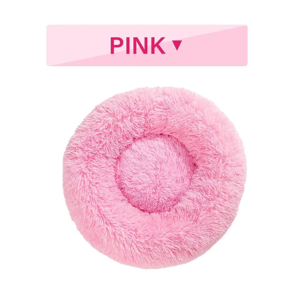 Fluffy donut-shaped pet bed in long plush fabric, showing raised rim, available in multiple colours.