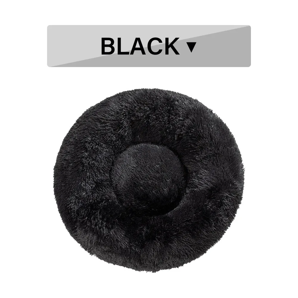 Fluffy donut-shaped pet bed in long plush fabric, showing raised rim, available in multiple colours.