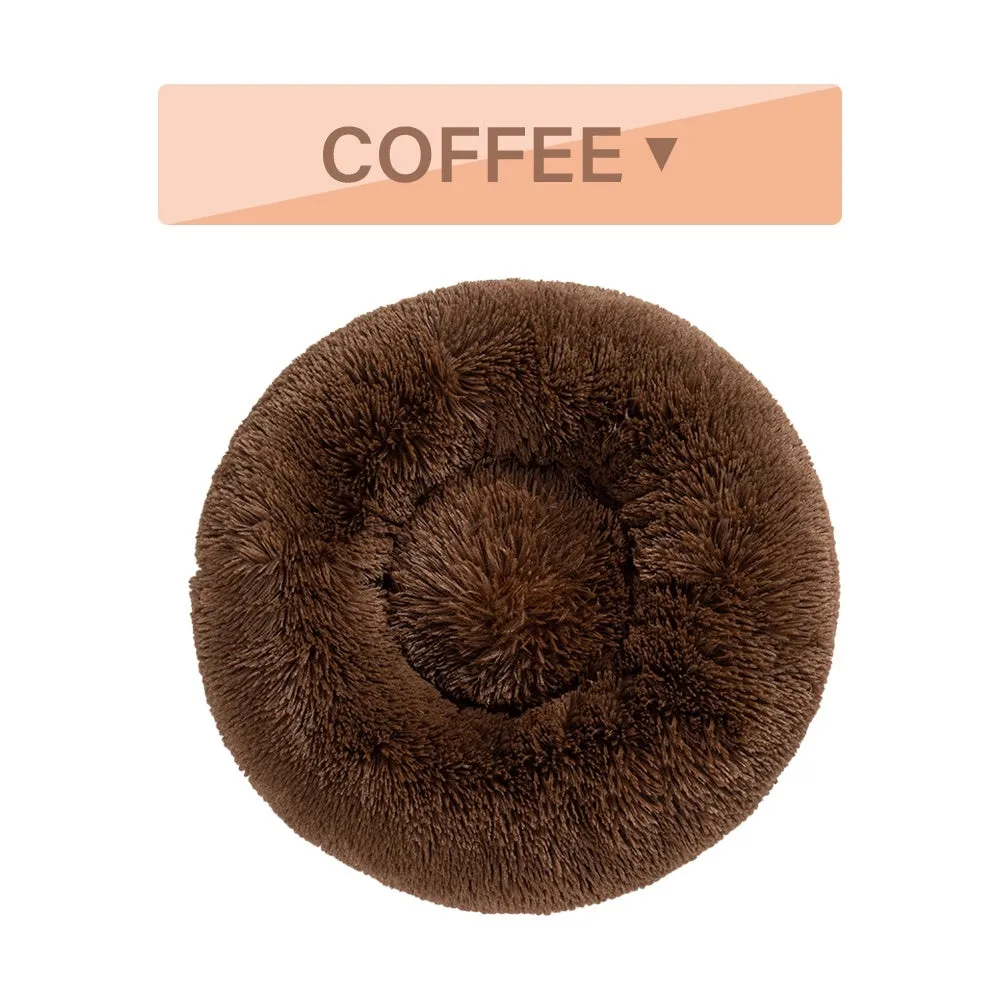 Fluffy donut-shaped pet bed in long plush fabric, showing raised rim, available in multiple colours.