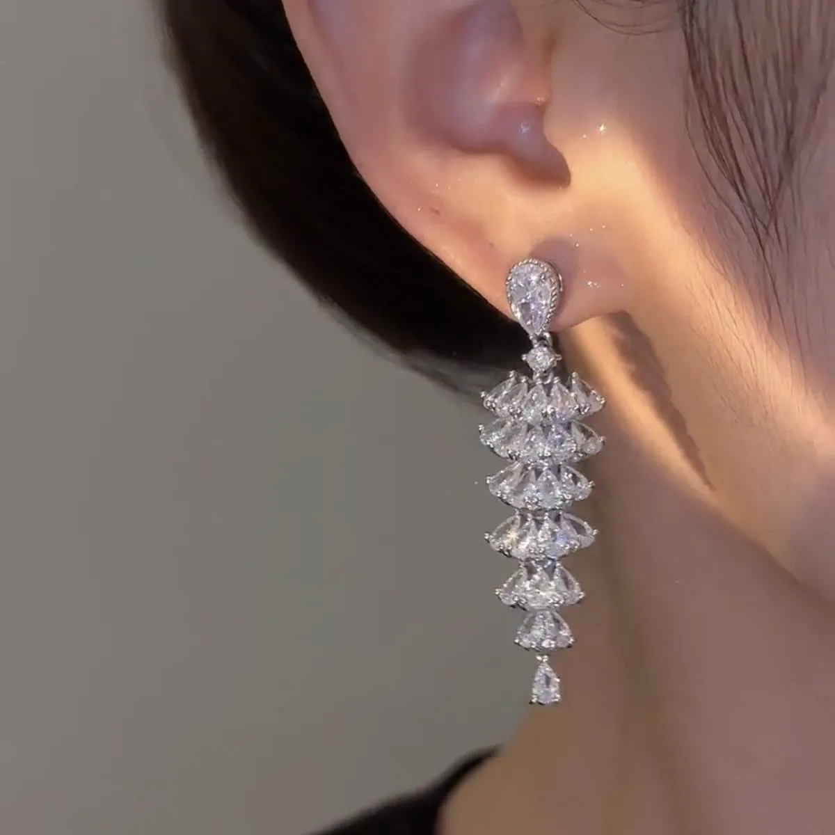Women's silver pagoda Christmas tree drop earrings with sparkling zircon details on copper.