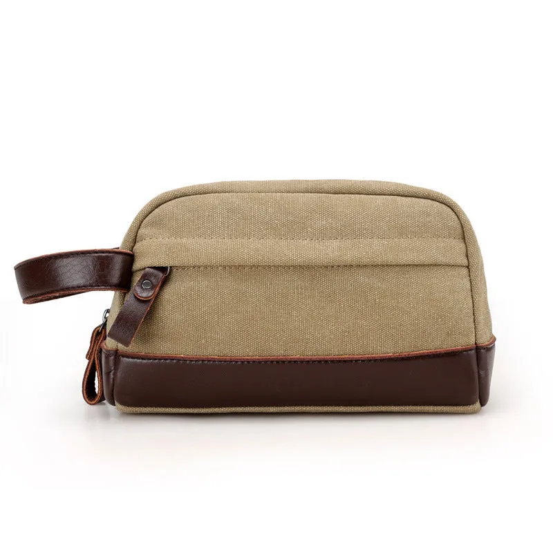 Men's canvas changing wallet in horizontal square shape with soft carry handle and zippered compartments, available in five solid colours.