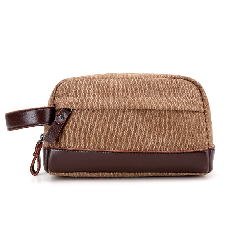 Men's canvas changing wallet in horizontal square shape with soft carry handle and zippered compartments, available in five solid colours.