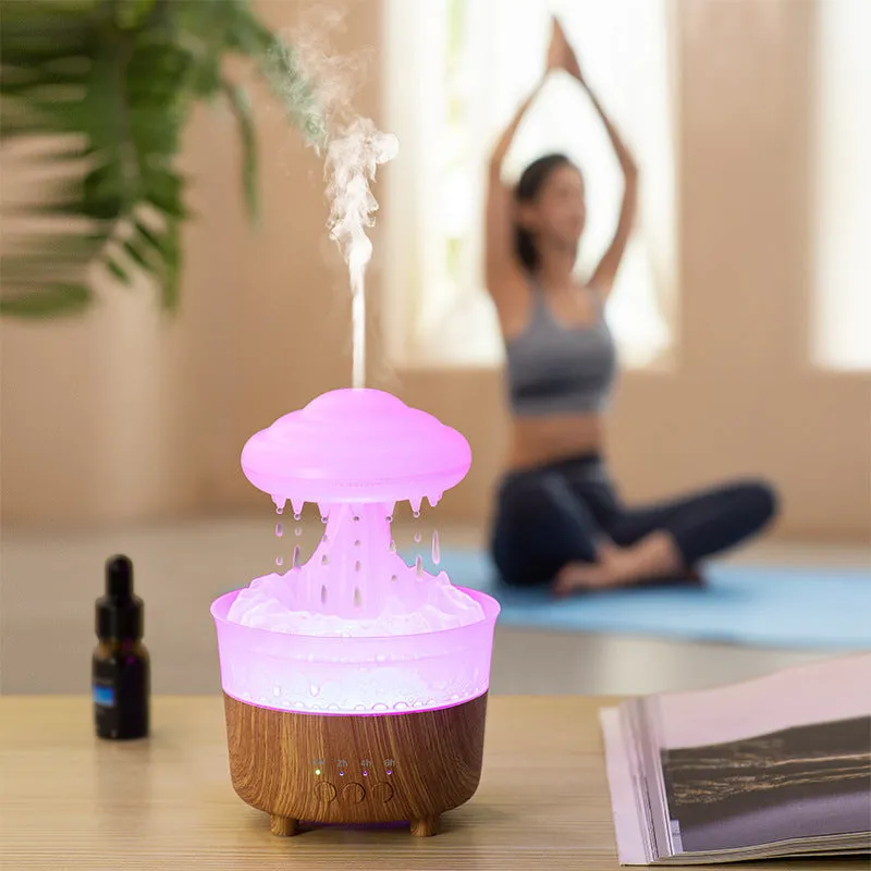 Wood grain white cloud-shaped humidifier diffuser with glowing LED lights and water droplets.