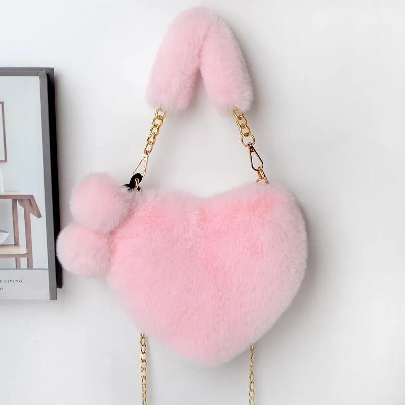 Women's soft plush heart-shaped handbag in medium size with adjustable shoulder strap