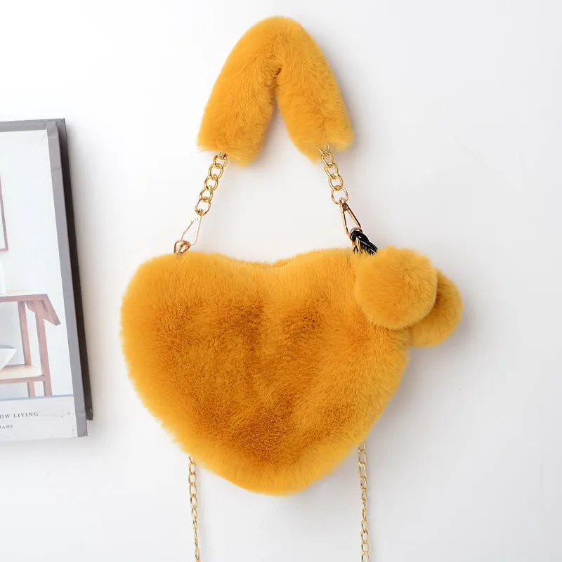 Women's soft plush heart-shaped handbag in medium size with adjustable shoulder strap