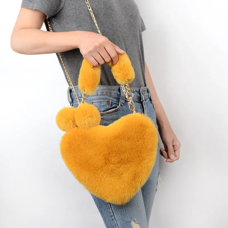 Women's soft plush heart-shaped handbag in medium size with adjustable shoulder strap