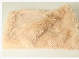 Dog blanket in long plush wool-polyester blend showing three size options and colour variations