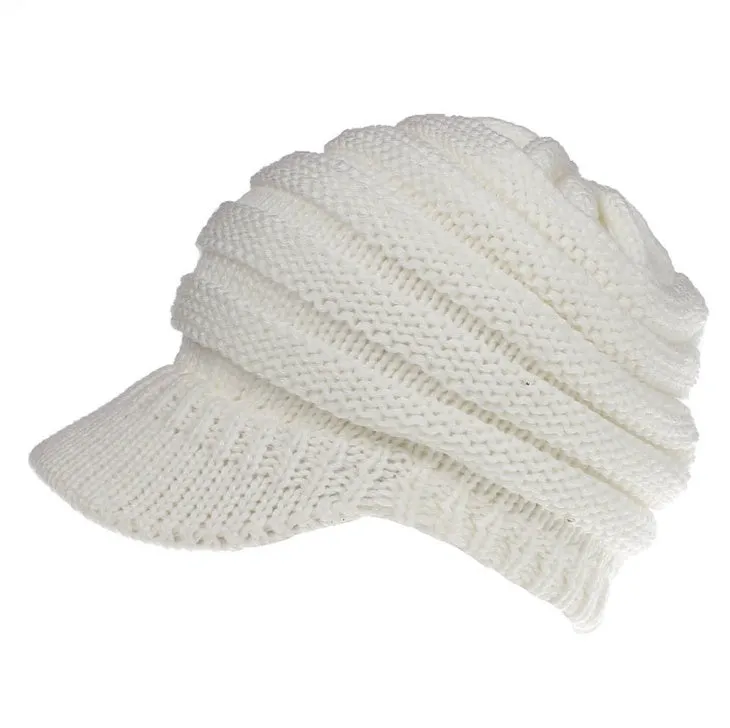 Acrylic knitted ponytail beanie hat for women in a neutral colour, shown on a model with a high ponytail.