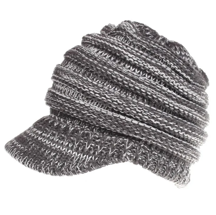 Acrylic knitted ponytail beanie hat for women in a neutral colour, shown on a model with a high ponytail.
