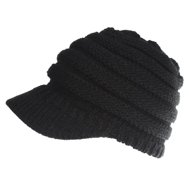 Acrylic knitted ponytail beanie hat for women in a neutral colour, shown on a model with a high ponytail.