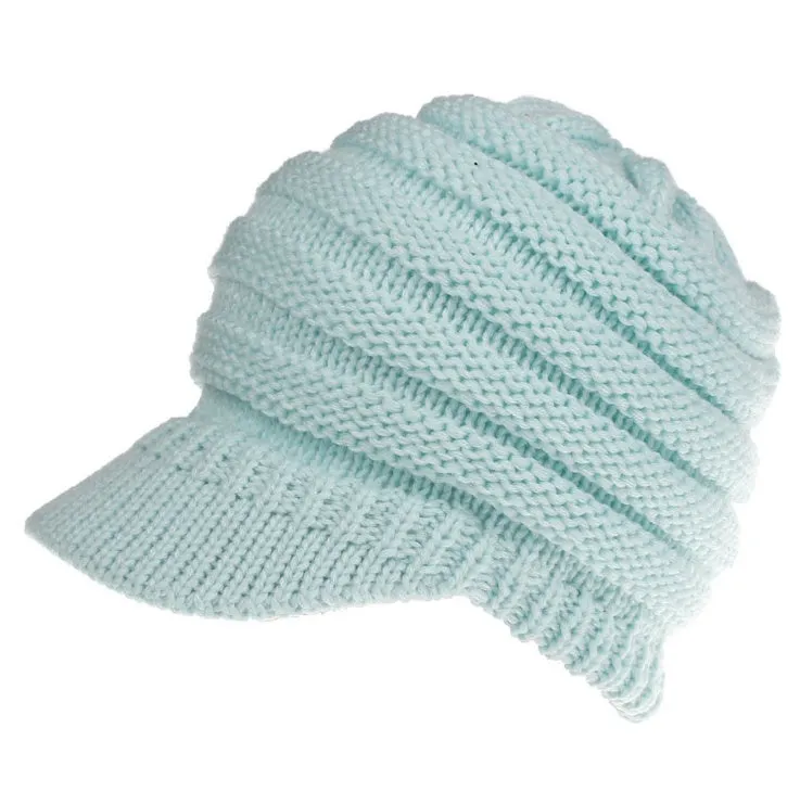 Acrylic knitted ponytail beanie hat for women in a neutral colour, shown on a model with a high ponytail.