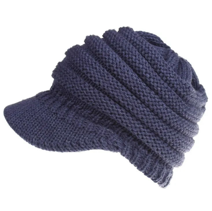Acrylic knitted ponytail beanie hat for women in a neutral colour, shown on a model with a high ponytail.