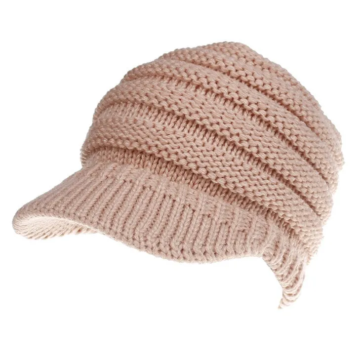 Acrylic knitted ponytail beanie hat for women in a neutral colour, shown on a model with a high ponytail.