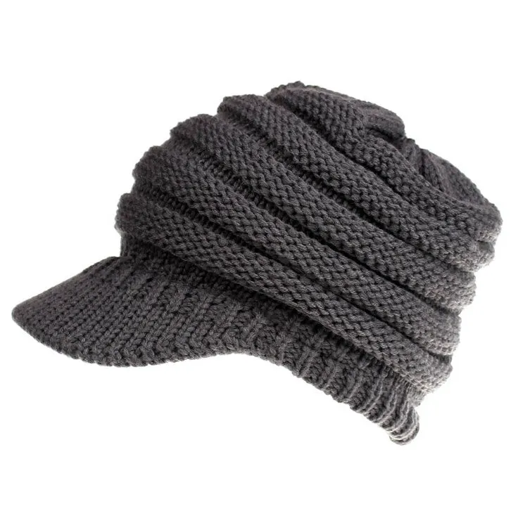 Acrylic knitted ponytail beanie hat for women in a neutral colour, shown on a model with a high ponytail.