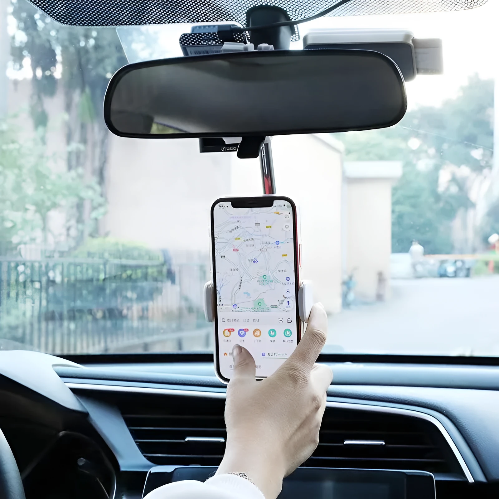 Black ABS plastic mobile phone bracket mounted on car rearview mirror showing smartphone in holder