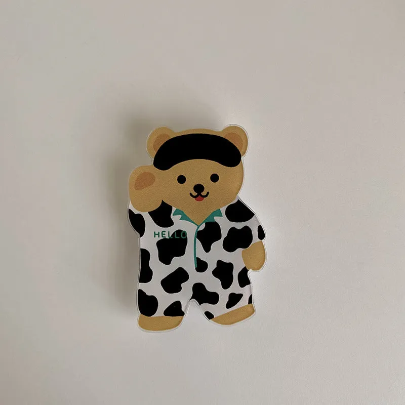 White epoxy resin Brown Bear series phone bracket with bear holding flower design on desk