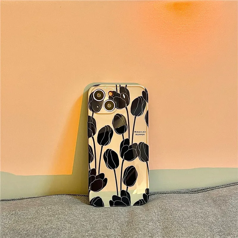 Black silicone iPhone case with a detailed tulip floral pattern on the back.