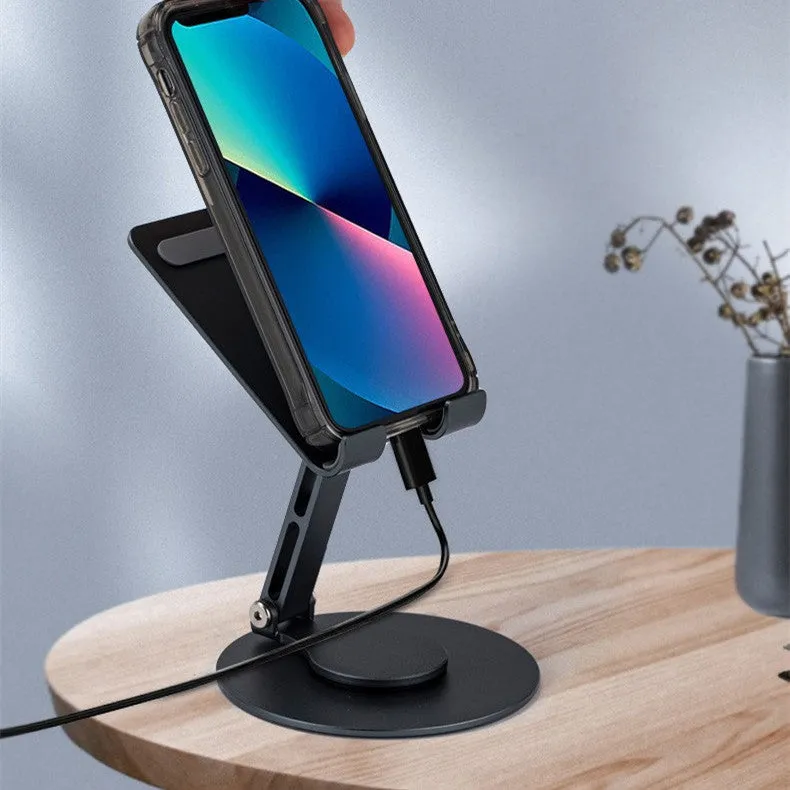 Grey aluminium alloy rotating mobile phone bracket on desk with silica gel grip, 4.8 x 4.2 x 1.4 cm, holding a smartphone in landscape mode