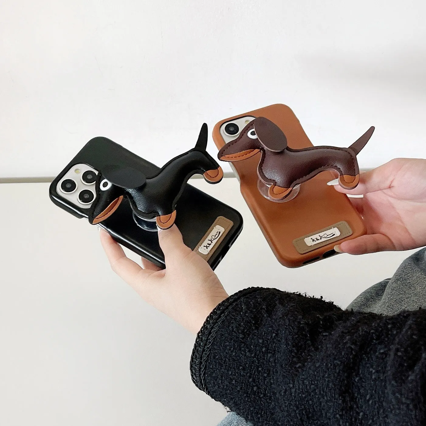 Sausage dog bracket phone case with imitation leather finish in black shell, compatible with iPhone models