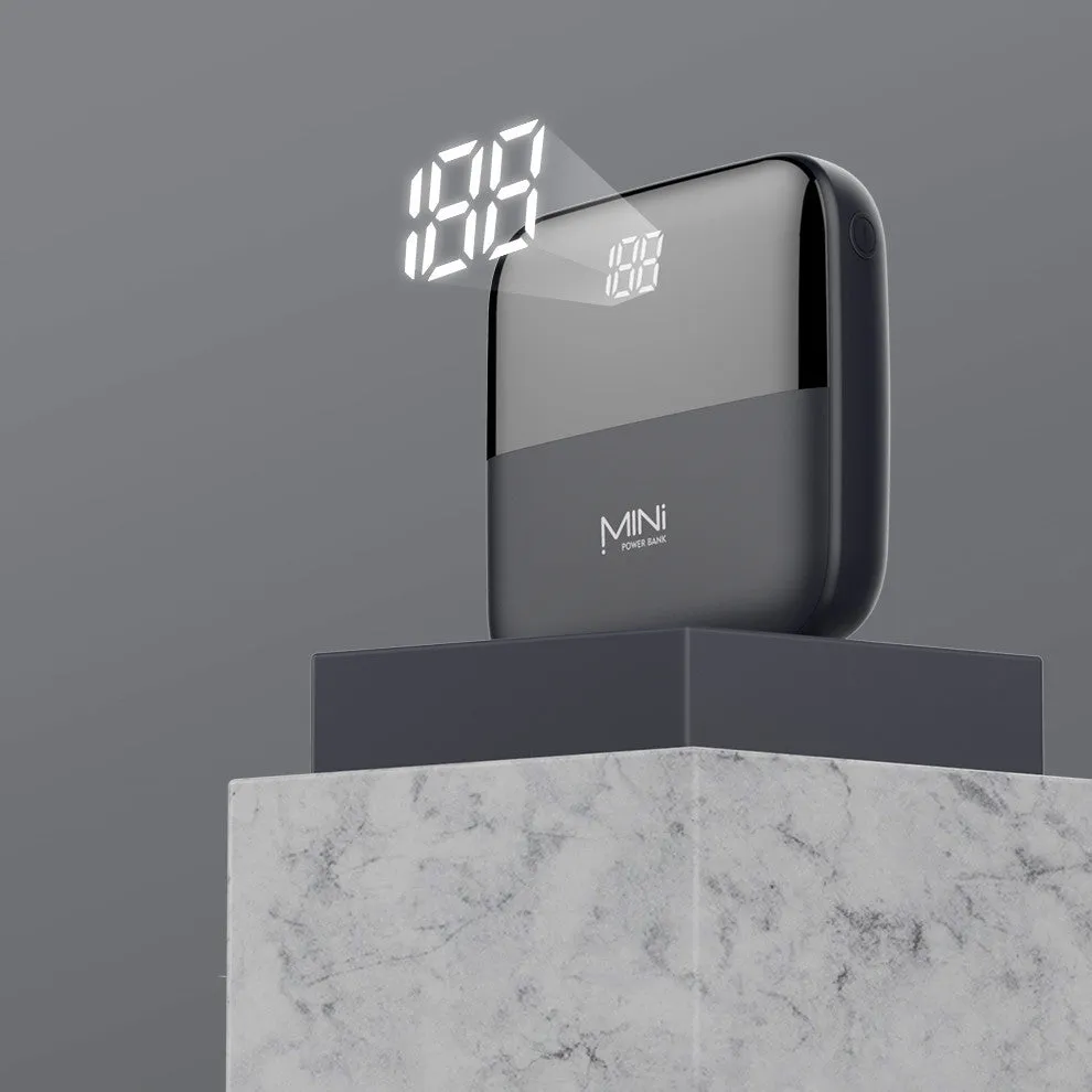 Black Android 10000mAh portable power bank with digital display showing battery percentage and dual USB ports.