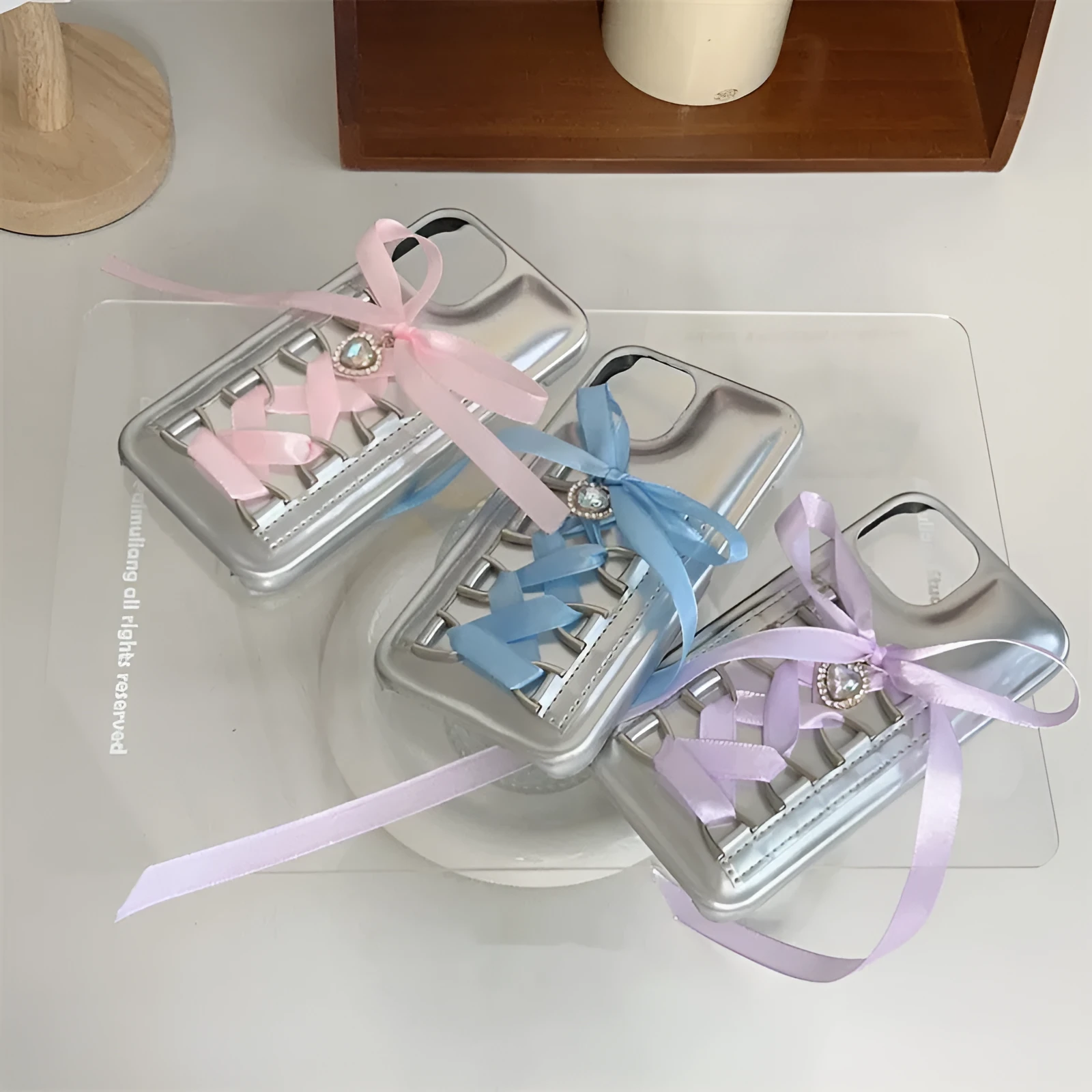 Electroplated silver PC phone case with shoelace bow for iPhone 15, blue colour