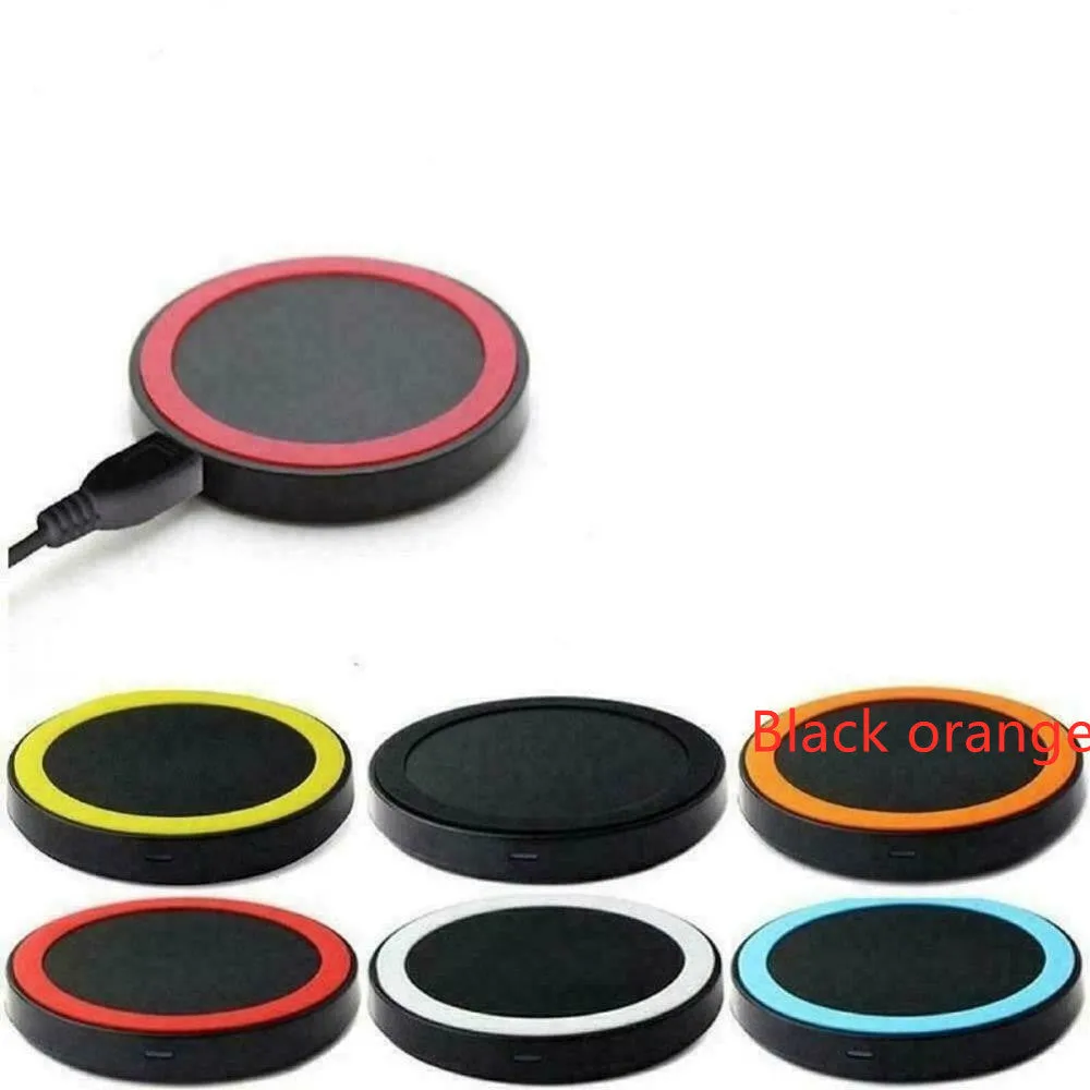 Qi wireless charging base for mobile phones in six colours on a wooden table.