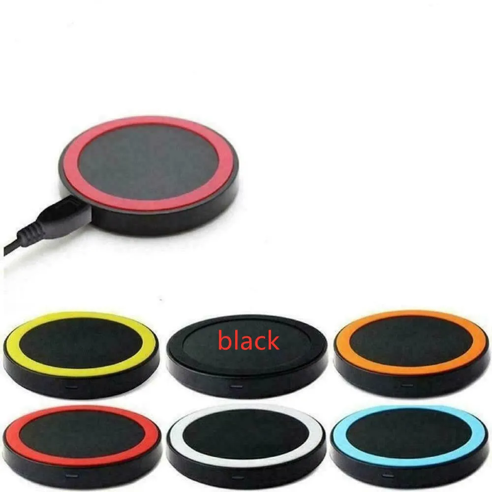 Qi wireless charging base for mobile phones in six colours on a wooden table.