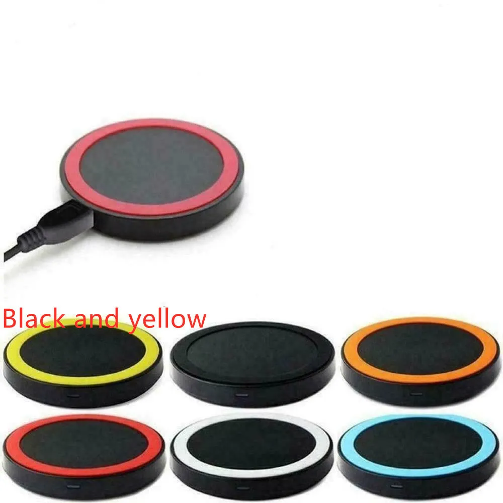 Qi wireless charging base for mobile phones in six colours on a wooden table.