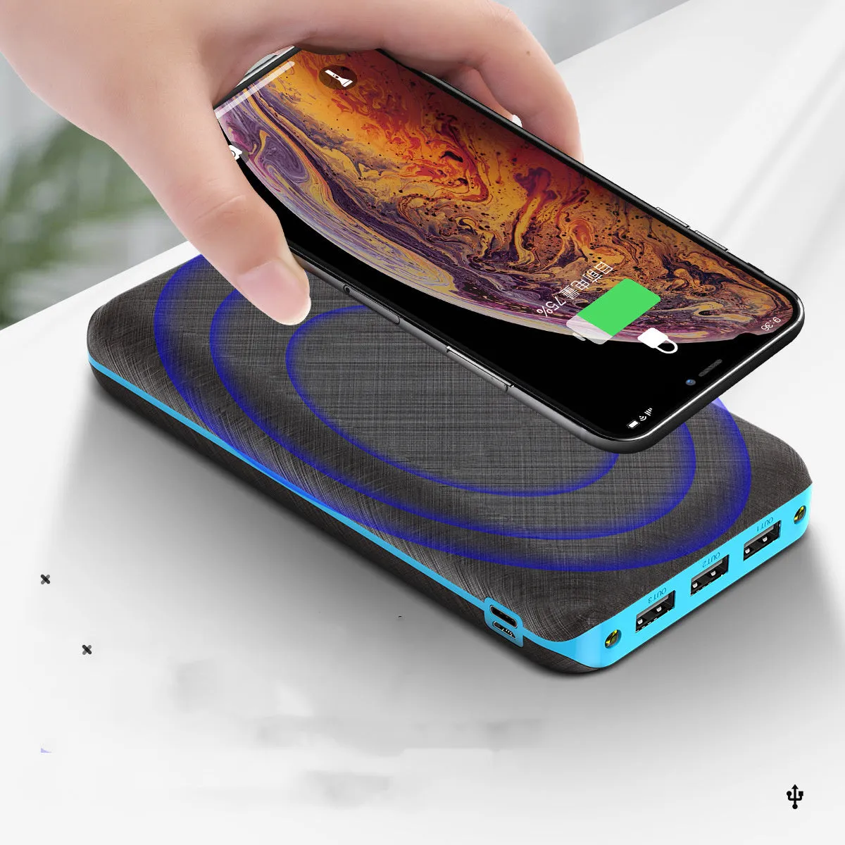 Black wireless charging power bank with three USB ports for iPhone Samsung and Xiaomi phones
