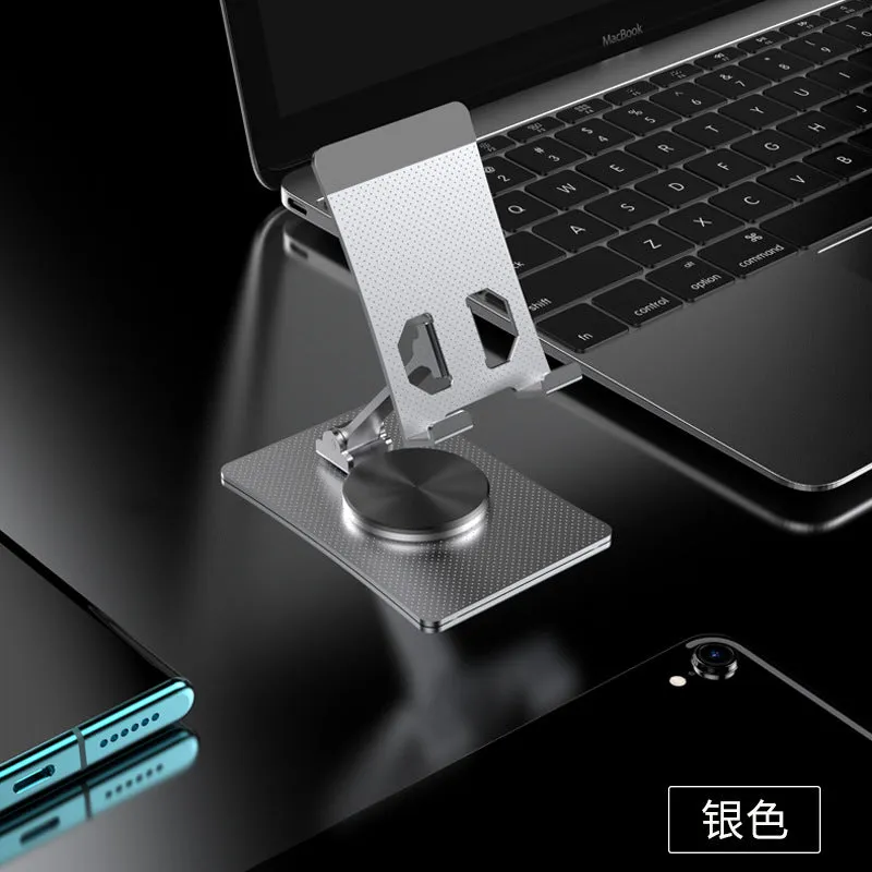 Aluminium alloy rotating mobile phone bracket in silver on a desk, showing three-axis joint and metal texture finish