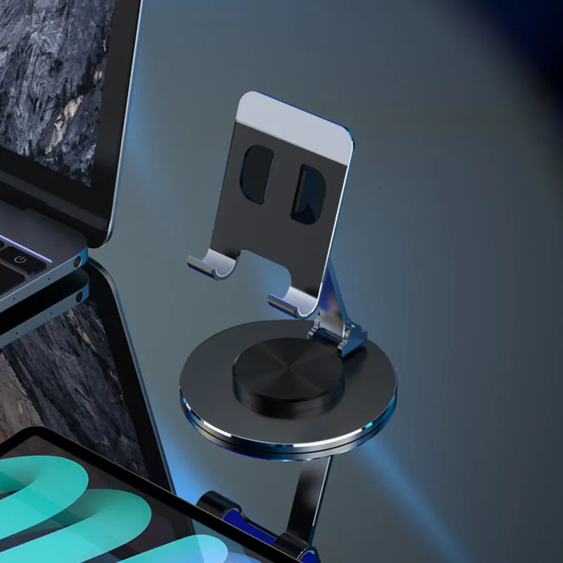 Aluminium alloy rotating mobile phone bracket in silver on a desk, showing three-axis joint and metal texture finish