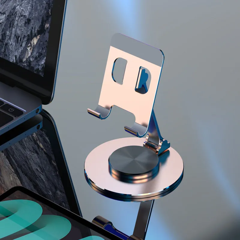 Aluminium alloy rotating mobile phone bracket in silver on a desk, showing three-axis joint and metal texture finish