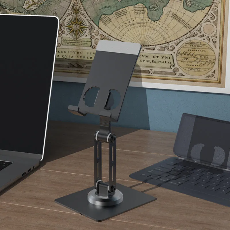 Aluminium alloy rotating mobile phone bracket in silver on a desk, showing three-axis joint and metal texture finish