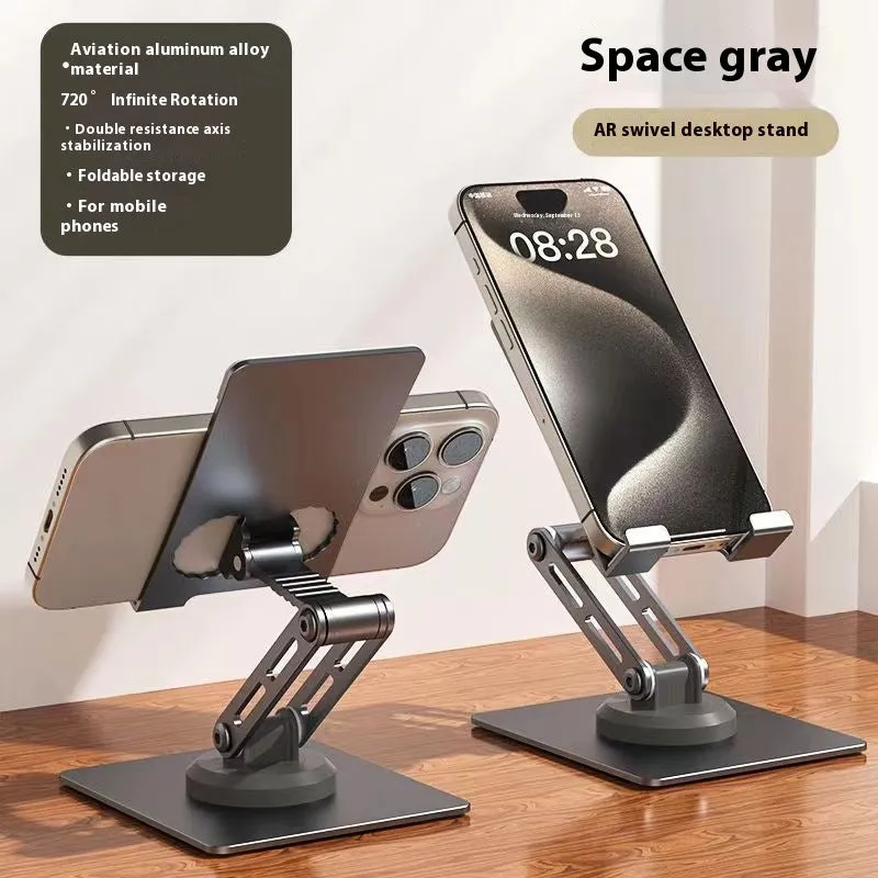 Aluminium alloy rotating mobile phone bracket in silver on a desk, showing three-axis joint and metal texture finish