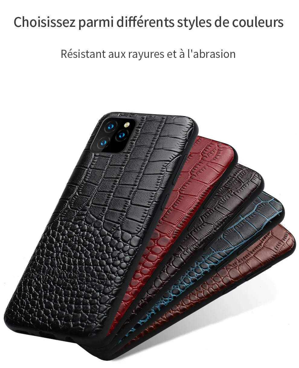 Handmade leather iPhone case with crocodile pattern texture in brown colour on a table.