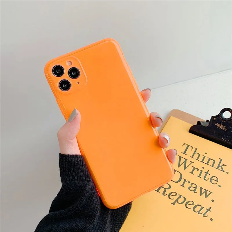 Transparent fluorescent TPU phone case in orange for iPhone 15 Pro Max showing slim back cover design