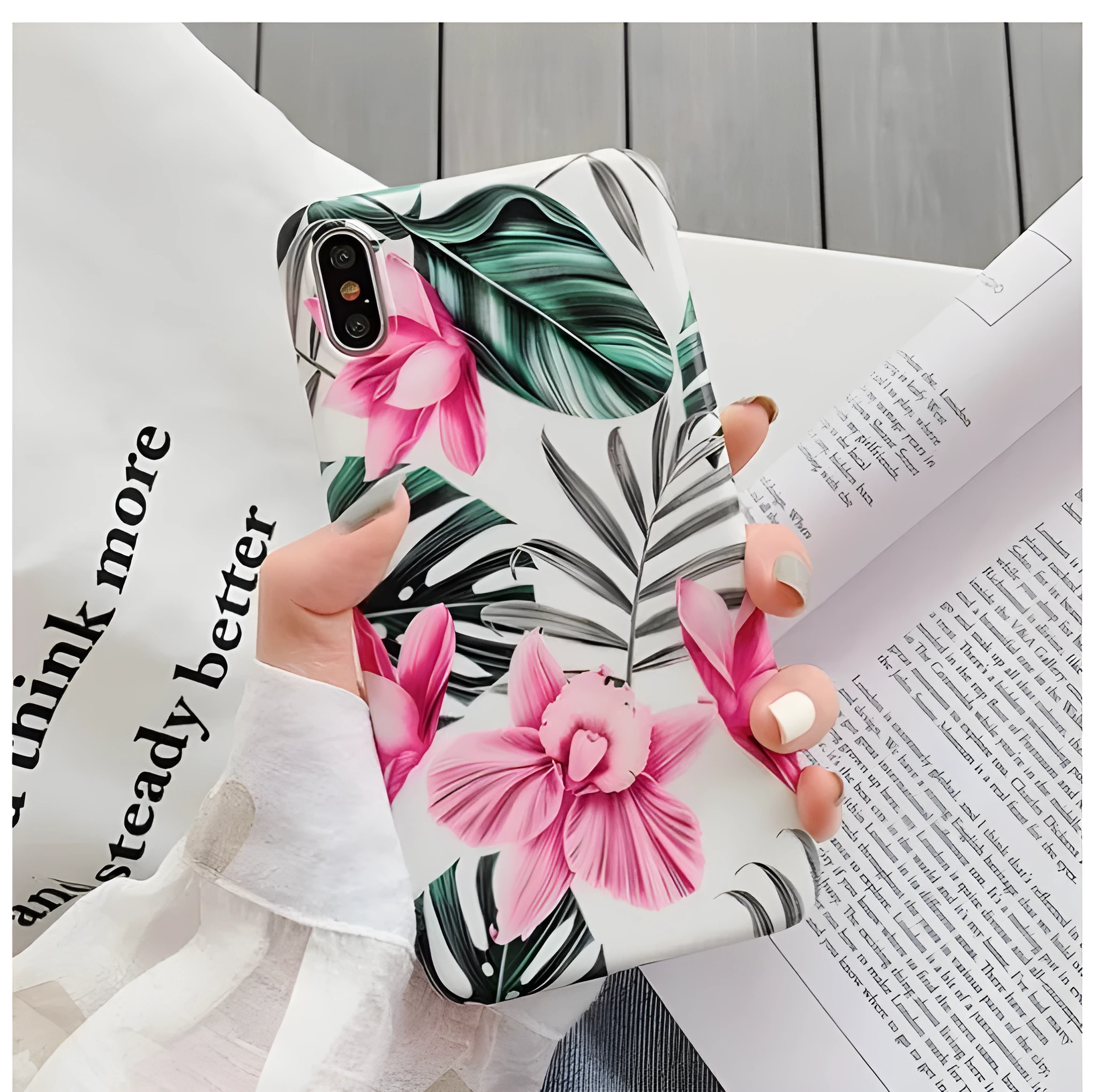 Pink flower design TPU phone case for iPhone on a table.