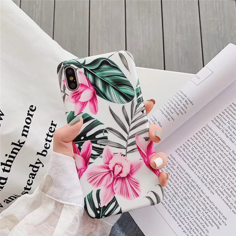 Pink flower design TPU phone case for iPhone on a table.