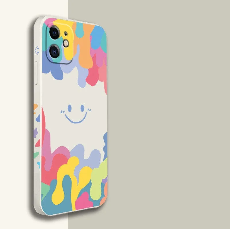 White silicone phone case with a rainbow smiley face design and a black lanyard attached.