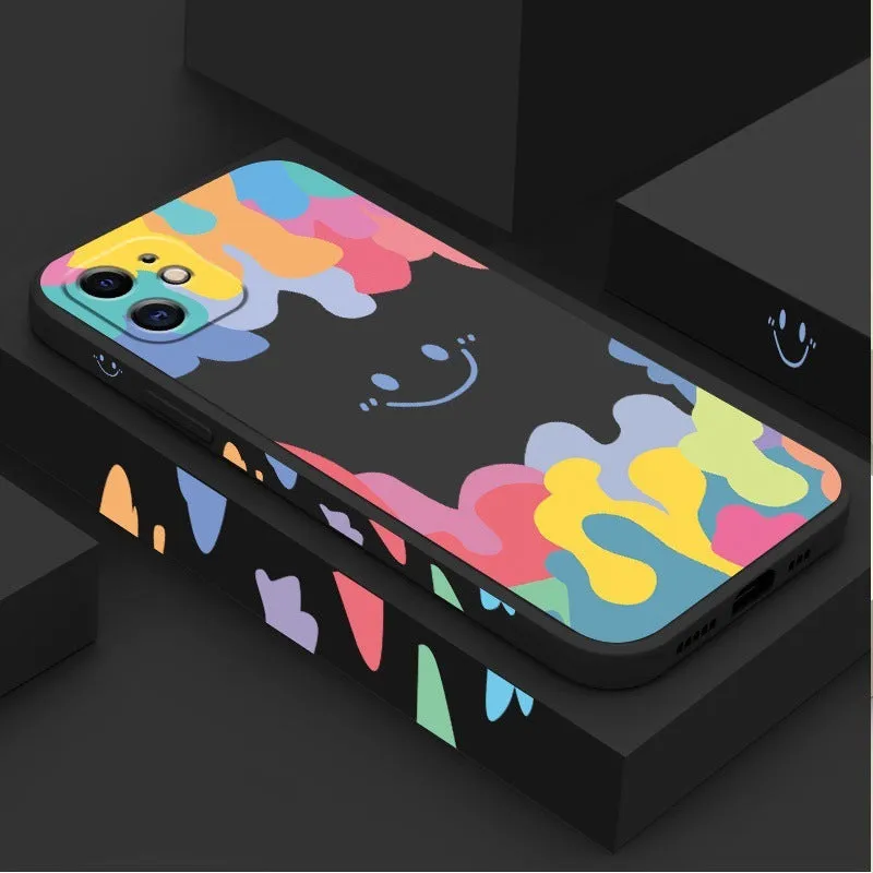 White silicone phone case with a rainbow smiley face design and a black lanyard attached.