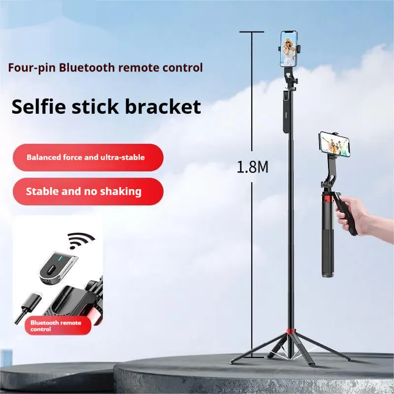 Bluetooth quadrupod selfie stick tripod with remote control, phone clamp, and four legs extended on a table