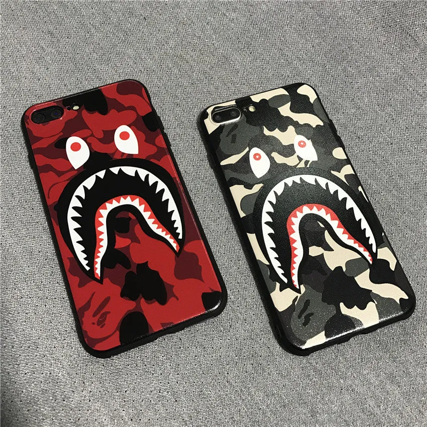 Frosted silicone phone case with shark mouth design in red, green, gray, and pink colours