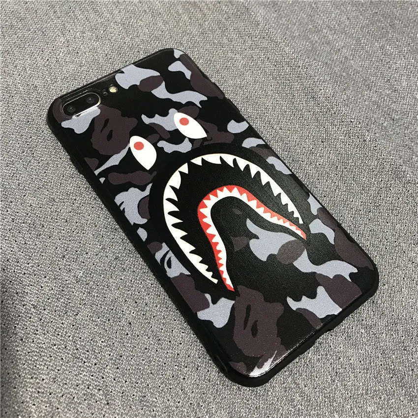 Frosted silicone phone case with shark mouth design in red, green, gray, and pink colours