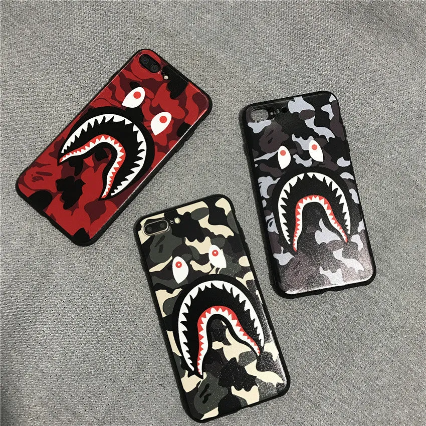 Frosted silicone phone case with shark mouth design in red, green, gray, and pink colours